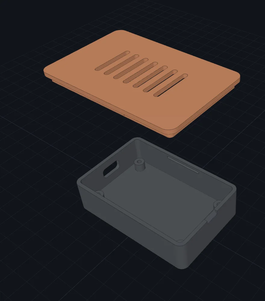 The enclosure pulled apart by the explode slider: an orange lid with ventilation slots floating above a grey box with four internal standoffs and a USB-C cutout.